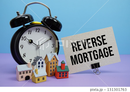 Reverse Mortgage phrase with Calculator, alarm clock, Model Houses Real Estate Financial Concept Reverse Mortgage phrase with Calculator, alarm clock, Model Houses Real Estate Financial Concept 131301763