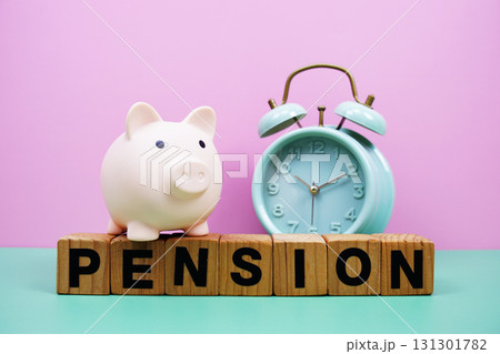 Pension alphabet letters with alarm clock on pink and green background Saving and financial concept 131301782