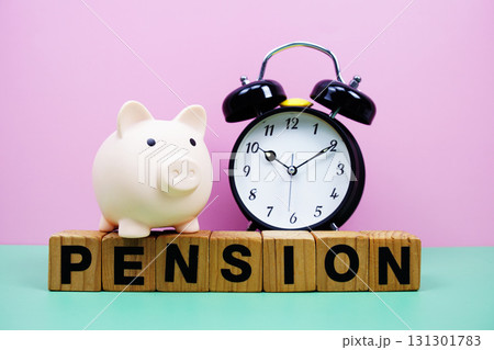 Pension alphabet letters with alarm clock on pink and green background Saving and financial concept 131301783