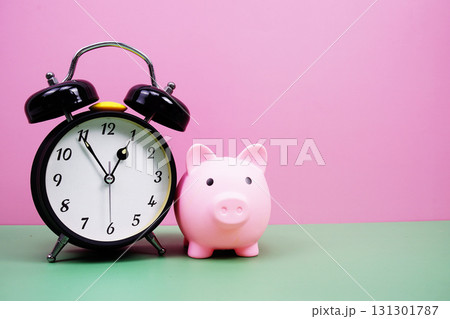 Piggy Saving with alarm clock on pink and green background 131301787