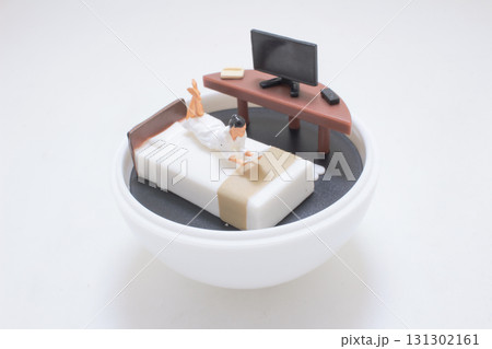 Miniature Bedroom Scene With Worker On Bed Reading Miniature Bedroom Scene With Worker On Bed Reading 131302161