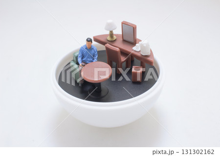 Small Man Working At Round Table and Desk Setup Small Man Working At Round Table and Desk Setup 131302162