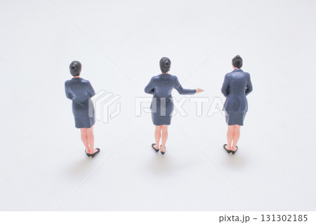 Three Small Female Business Figures In Blue Suits Standing 131302185