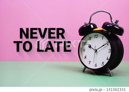 Black alarm clock on a pastel green and pink background with the text "Never To Late" 131302331
