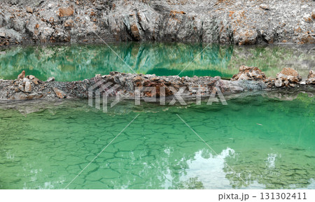 Scenic emerald pond with cliffs and reflection of trees. Scenic emerald pond with cliffs and reflection of trees. 131302411