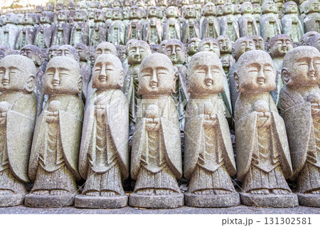 Stone Buddha statues arranged in rows at outdoor temple site at Kamakura, Kanagawa, Japan Stone Buddha statues arranged in rows at outdoor temple site at Kamakura, Kanagawa, Japan 131302581