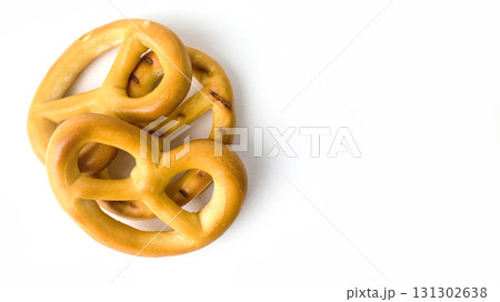Soft pretzels sit on a clean white surface. 131302638