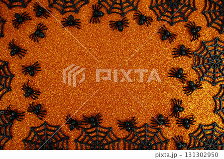Halloween background with small black spider, spiderwebs, and orange background for Halloween celebrations, party invitations, or seasonal promotions Halloween background with small black spider, spiderwebs, and orange background for Halloween celebrations, party invitations, or seasonal promotions 131302950