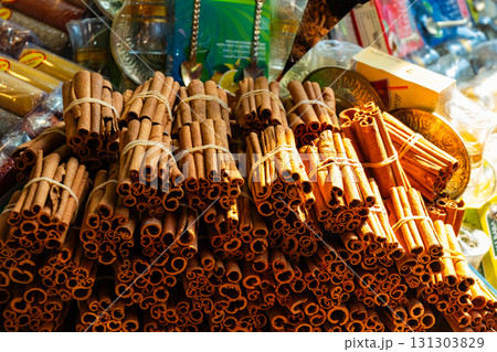 Aromatic cinnamon sticks displayed at a Turkish spice bazaar, symbolizing oriental flavors, traditional trade, and authentic culinary culture. 131303829
