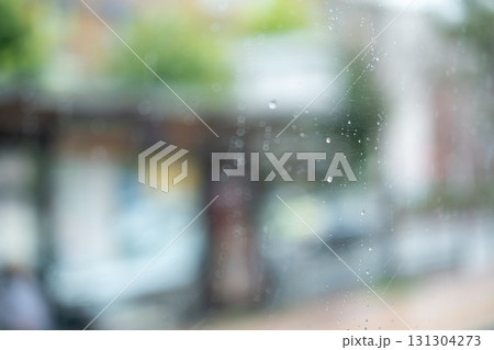 Rain drops on the bus glass, with blurred background Rain drops on the bus glass, with blurred background 131304273