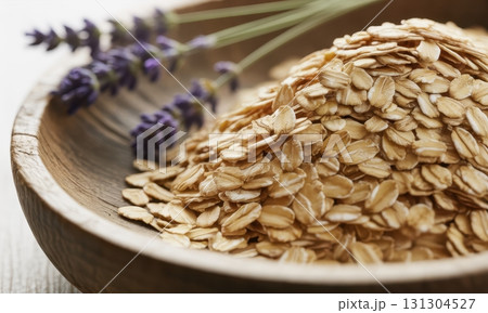 Close up of rolled oats and fresh lavender in a rustic wooden bowl for healthy breakfast Close up of rolled oats and fresh lavender in a rustic wooden bowl for healthy breakfast 131304527