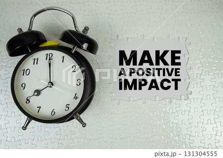 Make A Positive Impact text with alarm clock on white background Make A Positive Impact text with alarm clock on white background 131304555