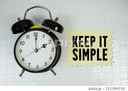 Keep It Simple text with alarm clock on yellow background 131304558