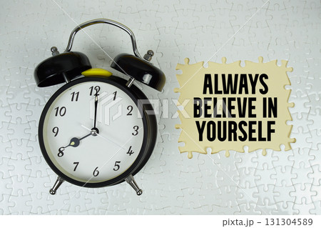 Always Believe In Yourself text with alarm clock on yellow background Always Believe In Yourself text with alarm clock on yellow background 131304589