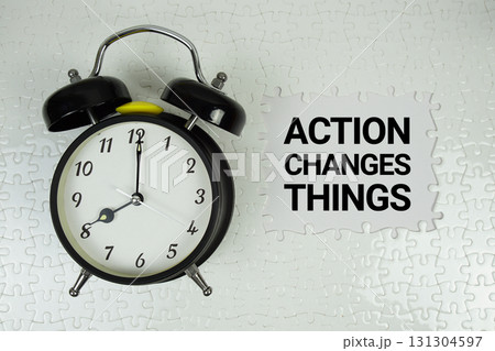 Action Changes Things text with alarm clock on white background 131304597