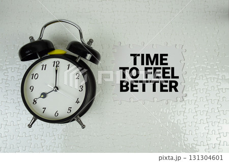 Time To Feel Better text with alarm clock on white background Time To Feel Better text with alarm clock on white background 131304601