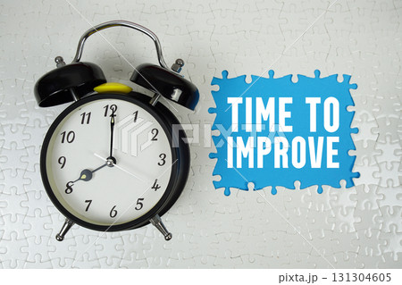 Time To Improve text with alarm clock on blue background Time To Improve text with alarm clock on blue background 131304605