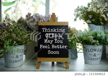 Easel with Motivational And Inspirational Quotes "Thinking Of You. May You Feel Better Soon" Easel with Motivational And Inspirational Quotes "Thinking Of You. May You Feel Better Soon" 131304622