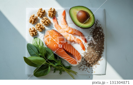 Healthy fats assortment, salmon, shrimp, avocado, walnuts, chia seeds, and greens 131304871