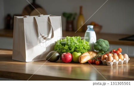 White reusable shopping bag with fresh healthy groceries on a modern kitchen counter White reusable shopping bag with fresh healthy groceries on a modern kitchen counter 131305501