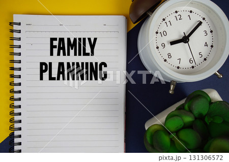 Family Planning text written on notepad with alarm clock on blue background Family Planning text written on notepad with alarm clock on blue background 131306572