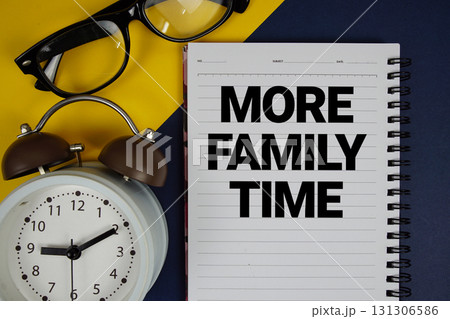 More Family Time text written on notepad with alarm clock on blue background More Family Time text written on notepad with alarm clock on blue background 131306586