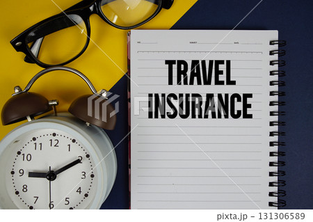 Travel Insurance text written on notepad with alarm clock on blue background Travel Insurance text written on notepad with alarm clock on blue background 131306589