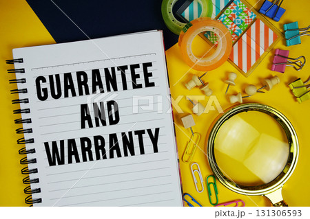 Guarantee And Warranty text with magnifying glass and stationery on yellow background Guarantee And Warranty text with magnifying glass and stationery on yellow background 131306593
