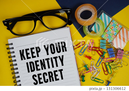 Keep Your Identity Secret text with eyeglasses and stationery on yellow background Keep Your Identity Secret text with eyeglasses and stationery on yellow background 131306612