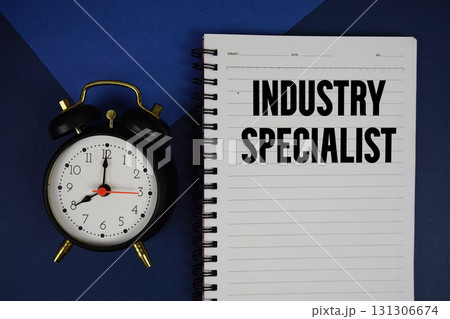 Industry Specialist text written on notepad with alarm clock on blue background 131306674