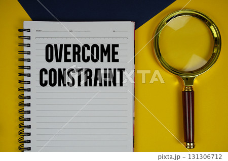Overcome Constraint text with magnifying glass on yellow background Overcome Constraint text with magnifying glass on yellow background 131306712