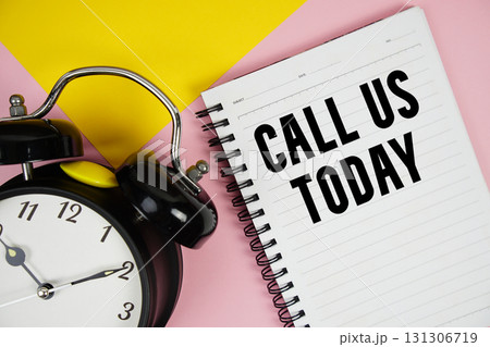 Call Us Today text written on notepad with alarm clock on pink background Call Us Today text written on notepad with alarm clock on pink background 131306719