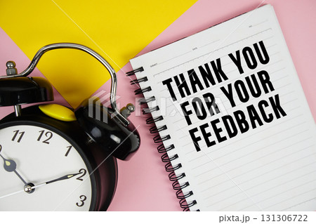 Thank you for your Feedback text written on notepad with alarm clock on pink background Thank you for your Feedback text written on notepad with alarm clock on pink background 131306722