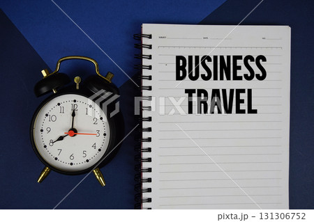 Business Travel text written on notepad with alarm clock on blue background Business Travel text written on notepad with alarm clock on blue background 131306752