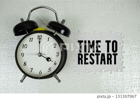Time to Restart text with alarm clock on white background Time to Restart text with alarm clock on white background 131307067