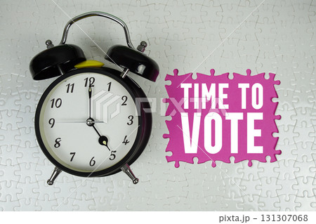 Time to Vote text with alarm clock on pink background Time to Vote text with alarm clock on pink background 131307068