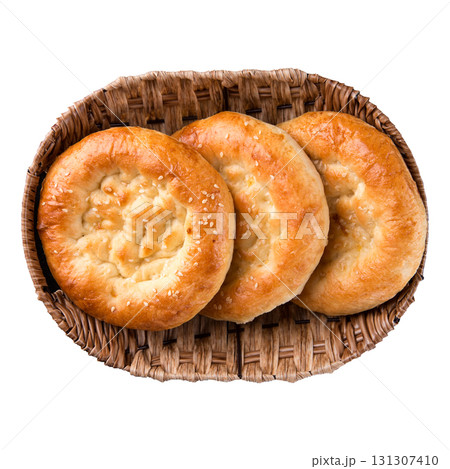 Isolated three Uzbek flatbreads in brown basket 131307410