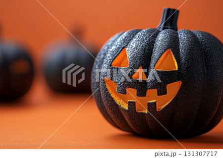 Black jack-o'-lantern with a glowing smile on a vibrant orange background for modern minimalist Halloween decor. 131307717