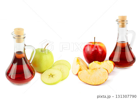 Two glass jugs with apple cider vinegar and fresh apples Two glass jugs with apple cider vinegar and fresh apples 131307790