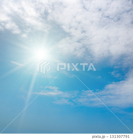Blue sky with bright sun and beautiful clouds Blue sky with bright sun and beautiful clouds 131307791