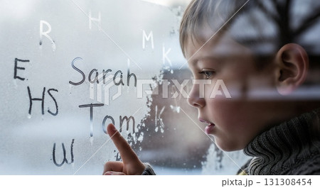 Child writing letters on foggy glass window. 131308454