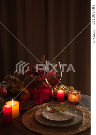 Autumn Table Setting with Pumpkins, Candles and Leaf Decor Autumn Table Setting with Pumpkins, Candles and Leaf Decor 131308495