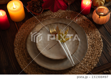 Autumn Table Setting with Pumpkins, Candles and Leaf Decor Autumn Table Setting with Pumpkins, Candles and Leaf Decor 131308497