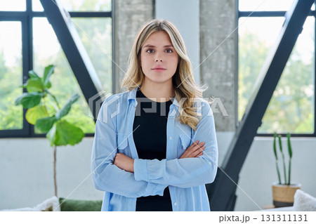 Portrait of young confident smiling woman in home interior Portrait of young confident smiling woman in home interior 131311131