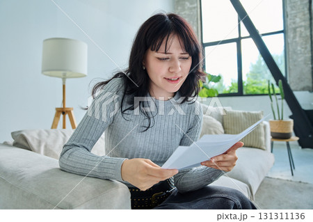Web cam view of young woman with papers, online meeting, video call Web cam view of young woman with papers, online meeting, video call 131311136