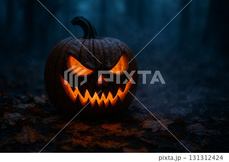 Glowing jack o lantern pumpkin with sinister carved face against a dark Halloween night sky. 131312424