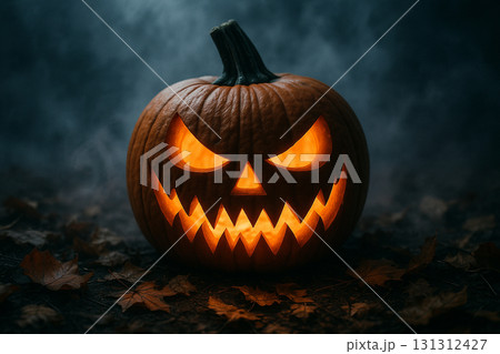 Close-up glowing jack o lantern pumpkin sitting in misty dark atmosphere for Halloween. 131312427
