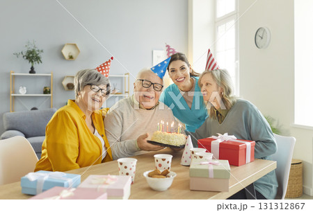 Senior people Happy Birthday party with cake for elderly with nurse, caregiver, support worker 131312867