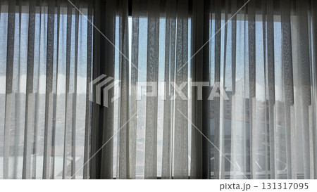 Light filtering through sheer curtains in a city room Light filtering through sheer curtains in a city room 131317095
