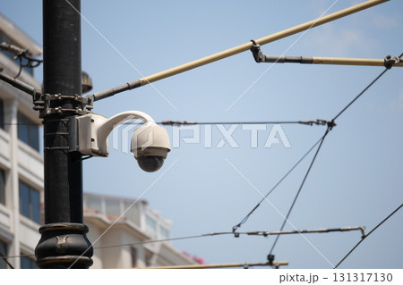 Surveillance camera on a street with overhead wires Surveillance camera on a street with overhead wires 131317130